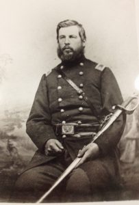 Portrait of Westel Willoughby in military uniform holding a sword. 