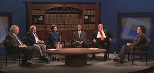 Five of the 1985 Court of Appeals judges are seated in front of a bookshelf near an interviewer. A coffee table is before them with some papers.