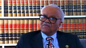 William T. Mason, Jr. during the March 2008 interview. He is wearing a suit and tie, and legal books are in the background.