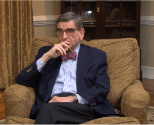 Steven Dalle Mura during the 2025 interview seated wearing a suit with a bow tie.