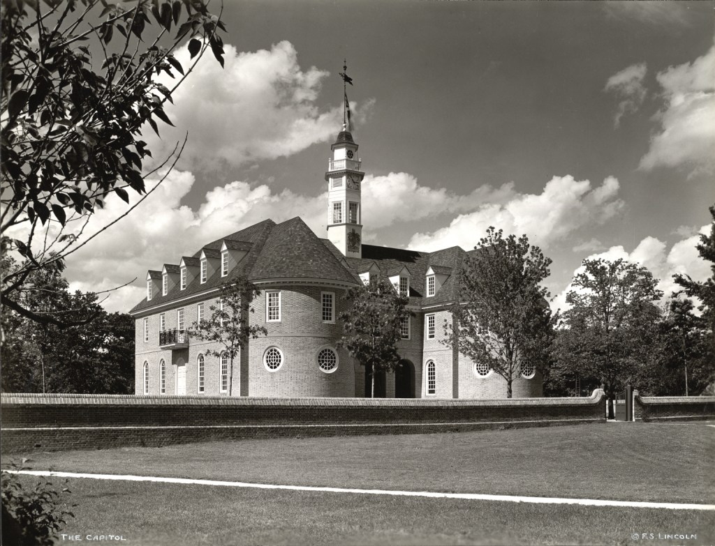 Black and white photo of a building with a steeple. 